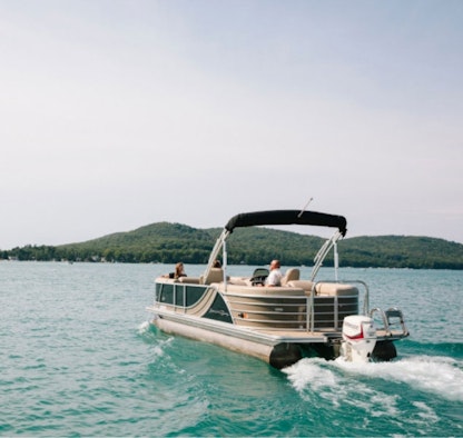 A pontoon boat on the water on a sunny day