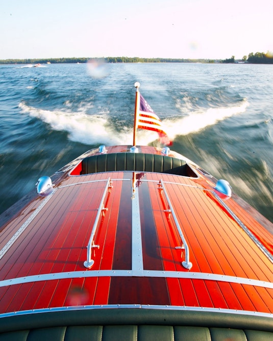 A classic boat speeding through water.